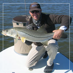 Captain Alex Boehm holds a huge snook